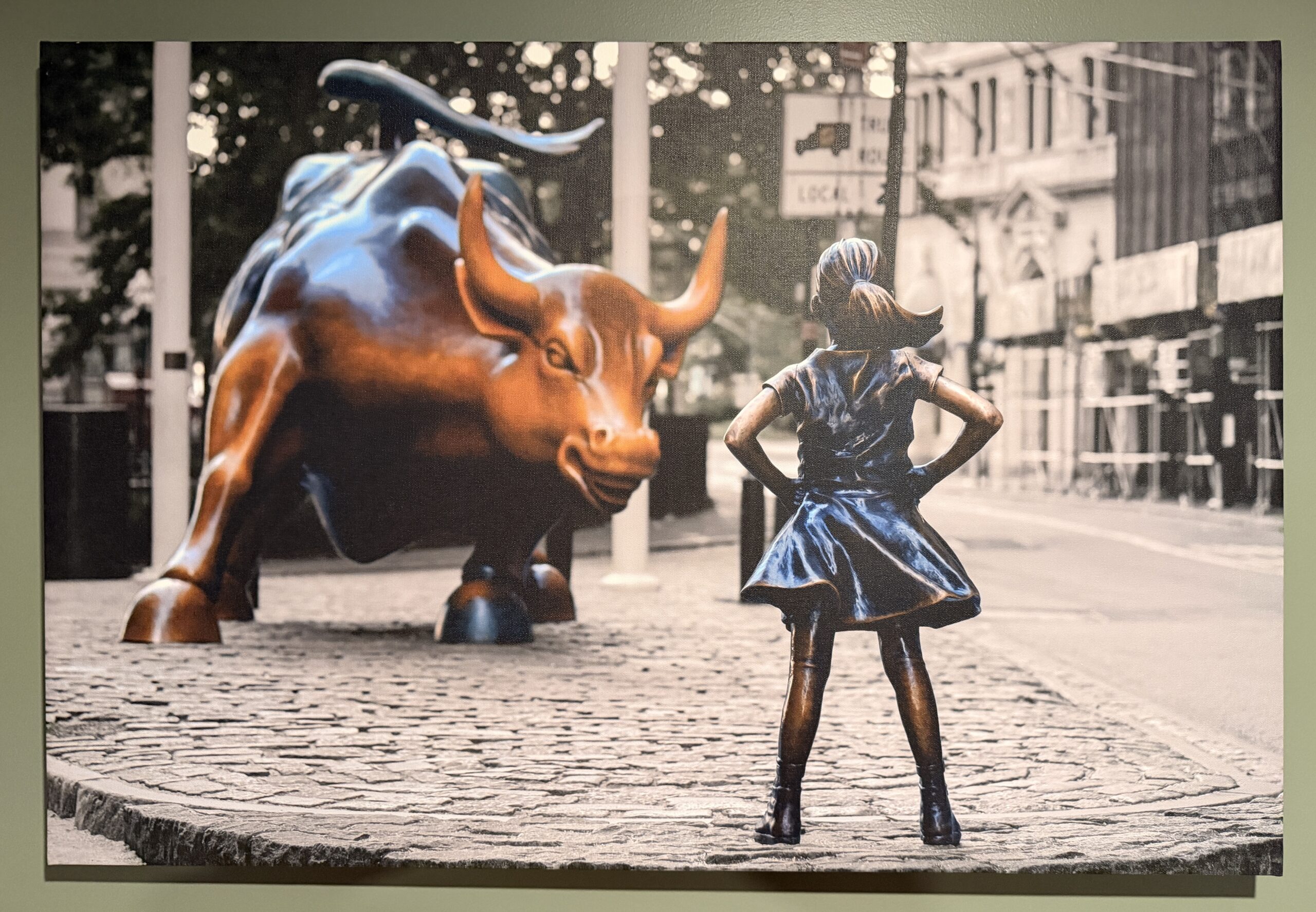 Print of Fearless Girl facing the New York Stock Market Bull in Shelley's Office